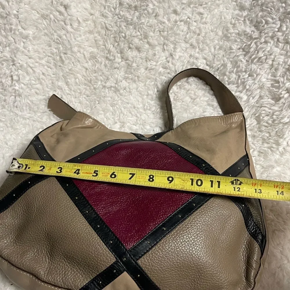 A. Bellucci leather Khaki Satchel with patch work accents, gay, burgundy &black.